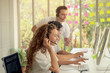© Stella - Young beautiful woman with headphones working at call center service desk consultant with her teammates while team supervisor helping new teammate and training junior to talk with the customer on hand