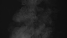 Water Vapor Slowly Rises From The Pan. White Steam Rises From A Large Pot That Is Behind The Scenes. Black Background. Filmed At A Speed Of 240fps