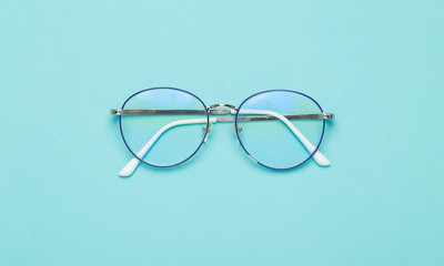 Wall Mural - Eye glasses isolated on blue background.