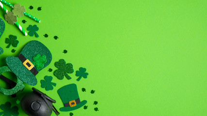 St Patricks Day banner design with Irish elf hats, pot of gold, shamrock and four-leaf clovers on green background. Happy St. Patrick's Day concept. Greeting card template, poster, flyer mockup