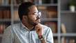 © fizkes - Thoughtful doubtful african businessman looking away lost in thoughts