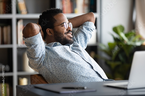 Cuadros en Lienzo Relaxed calm african businessman resting sit at office desk