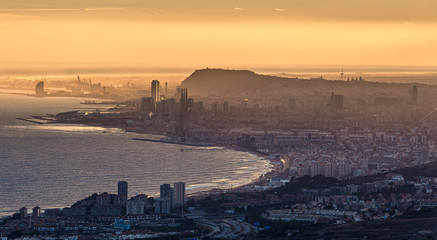 Wall Mural - Misty Distant Aerial View of Barcelona at Golden Hour