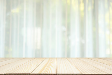 Empty wood table top with blur white curtain window and green garden background for product display template