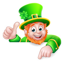 A Leprechaun St Patricks Day Cartoon Character Giving A Thumbs Up, Peeking Over A Sign And Pointing At It