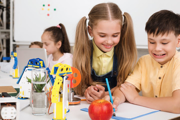 Poster - Smart pupils working on new robotics project, making notes