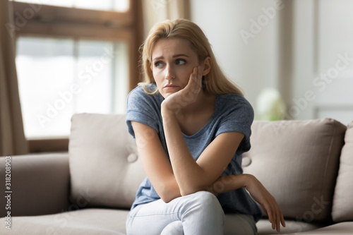 Photographie Stressed upset young blonde woman thinking of personal troubles.