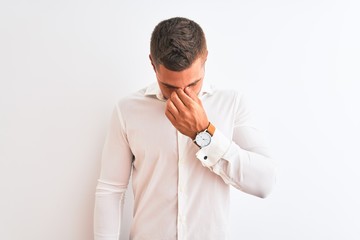 Canvas Print - Young handsome business man wearing elegant shirt over isolated background tired rubbing nose and eyes feeling fatigue and headache. Stress and frustration concept.