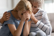 © fizkes - Older mature mommy comforting soothing supporting adult child.