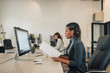 © bnenin - Mixed race business woman working with documents in coworking office.