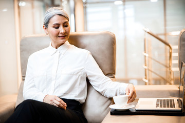 Wall Mural - Smiling lady putting coffee on the table stock photo