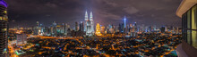 Panoramic Shot Of Illuminated Petronas Towers In City At Night