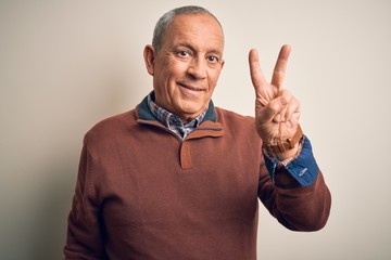 Senior handsome man  wearing elegant sweater standing over isolated white background showing and pointing up with fingers number two while smiling confident and happy.