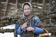 © lenafomichewa - A young Orthodox girl in a Russian headscarf holds willow branches in her hands. The concept of spring and Easter.