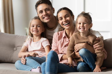 Wall Mural - Portrait of happy family with kids relaxing at home