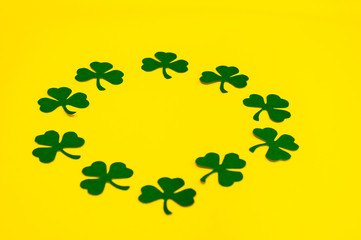 Wall Mural - Happy Saint Patrick's of handmade paper clover leaves on yellow background with copy space