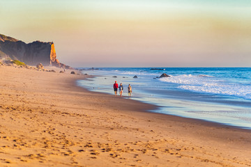 Canvas Print - Scenic view of the Zuma Beach in Malibu with people enjoying a walk along the beach