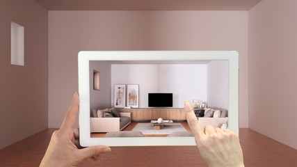 Wall Mural - augmented reality concept. hand holding tablet with ar application used to simulate furniture and de