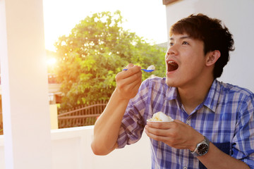 Asian thai man eating ice cream On holiday and the hot days