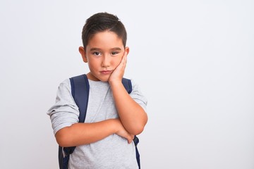 Sticker - Beautiful student kid boy wearing backpack standing over isolated white background thinking looking tired and bored with depression problems with crossed arms.