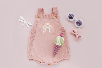 pink knitted bodysuit with toy ice cream and sunglasses. set of baby clothes and accessories summer.