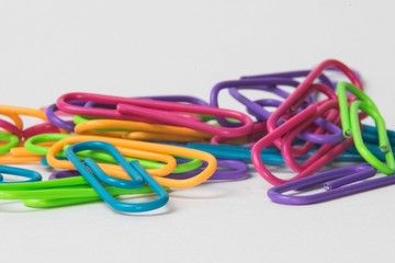 Close-up of multicolored paper clips on a white background