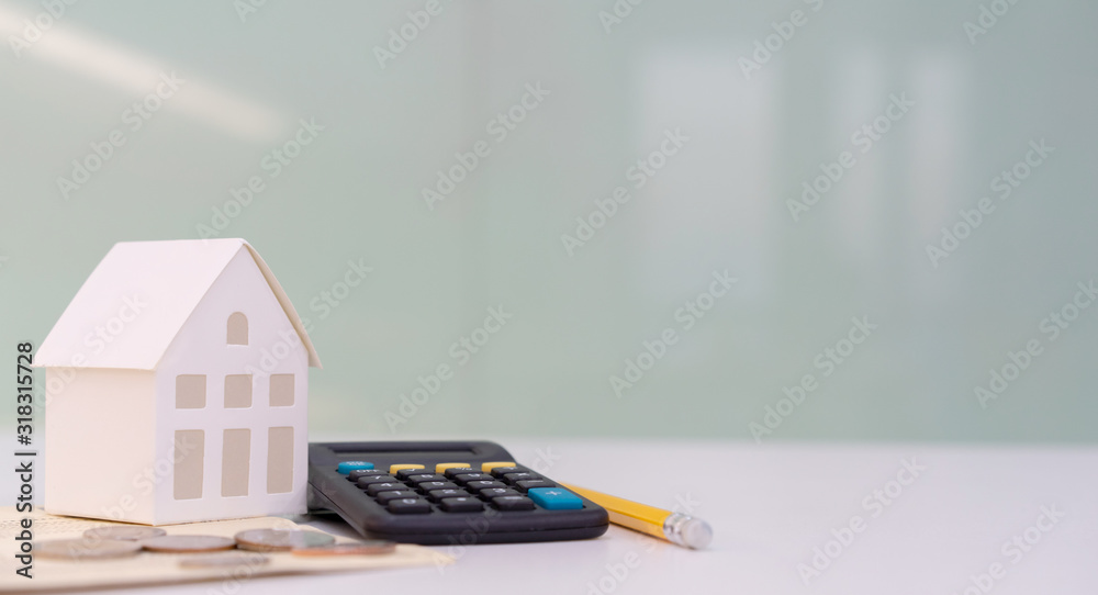 close up house's model on banking account book with calculator, coin and pencil on table for planning of home loan mortgage refinance or retention interest rates , business and financial concept - obrazy, fototapety, plakaty 