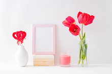 Home Interior With Decor Elements. Mockup With A Pink Frame, Red Tulips In A Vase On A Light Background