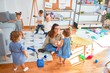 © Krakenimages.com - Beautiful teacher and group of toddlers playing around lots of toys at kindergarten