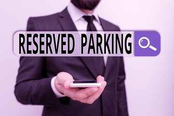 Wall Mural - Writing note showing Reserved Parking. Business concept for parking spaces that are reserved for specific individuals Male human wear formal work suit hold smartphone using hand