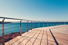 RAILING BY SEA AGAINST CLEAR SKY