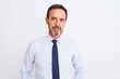© Krakenimages.com - Middle age businessman wearing elegant tie standing over isolated white background Relaxed with serious expression on face. Simple and natural looking at the camera.