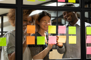 Wall Mural - smiling multiracial colleagues develop project on sticky notes