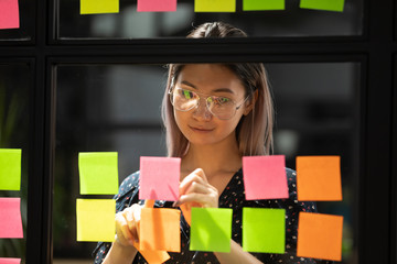 Wall Mural - millennial asian employee write ideas on sticky notes