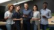 Group portrait of smiling multiethnic team posing in office