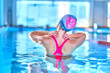 © Goffkein - Fit active woman doing water gymnastics and aerobics in a sports swimming pool in leisure center. Pool workout, treatment and prevention of back and neck disease, healthy back