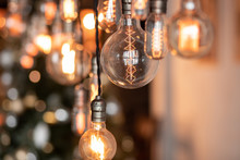 Edison Lamp Is Included In Loft Room, Against Background Blur Bokeh Wall