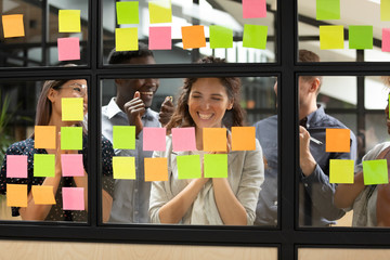 Wall Mural - overjoyed diverse colleagues complete group creative task