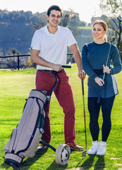 Wall Mural - Man and woman golf partners ready to enjoy game