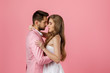 © Rychko Yevhen - happy couple in love embracing on pink background. man in a jacket and a woman in a dress are happy together. st valentines day. copy space