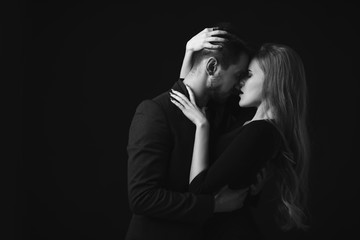 elegant couple in the tender passion. man and beautiful woman kissing. black and white