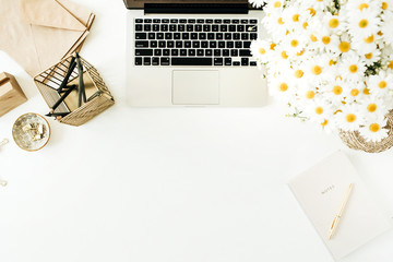 Wall Mural - Home office desk workspace with laptop, chamomile daisy flowers bouquet and notebook on white background. Flat lay, top view minimal freelancer work concept with copy space mockup.