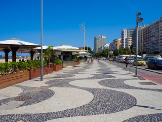 Fototapete - Copacabana beach with mosaic of sidewalk and kiosks in Rio de Janeiro, Brazil. Copacabana beach is the most famous beach in Rio de Janeiro. Sunny cityscape of Rio de Janeiro