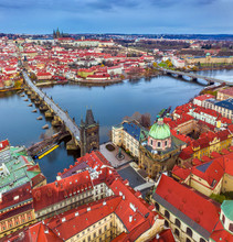 Prague, Czech Republic - Aerial Panoramic Drone View Of The World Famous Charles Bridge (Karluv Most) And St. Francis Of Assisi Church On A Winter Afternoon. St. Vitus Cathedral At Background