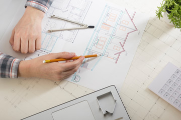 Architects working on blueprint, real estate project. Architect workplace - architectural project, blueprints, ruler, calculator, laptop and divider compass. Construction concept. Engineering tools.