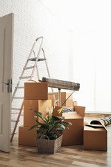 Wall Mural - Cardboard boxes and household stuff in living room. Moving day