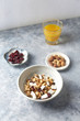 © Eugeniusz Dudziński - Bowl of granola with nuts, cranberry and cocoanut. Concept for a tasty and healthy meal. Stone / wooden background.