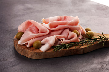 Sliced ham on wooden background. Fresh prosciutto. Pork ham sliced. pork meat cutting