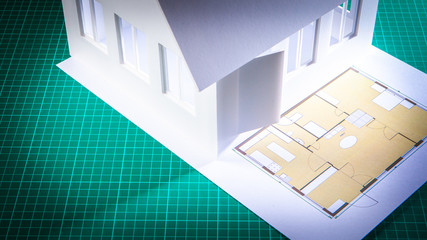 Poster - Layout of the cottage with white walls and building plan. Desktop of architect. Architectural and construction workshop. Development of the project of a country house. Layout of the cottage.