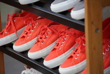 Close-Up Of Shoes In Shelves At Store For Sale